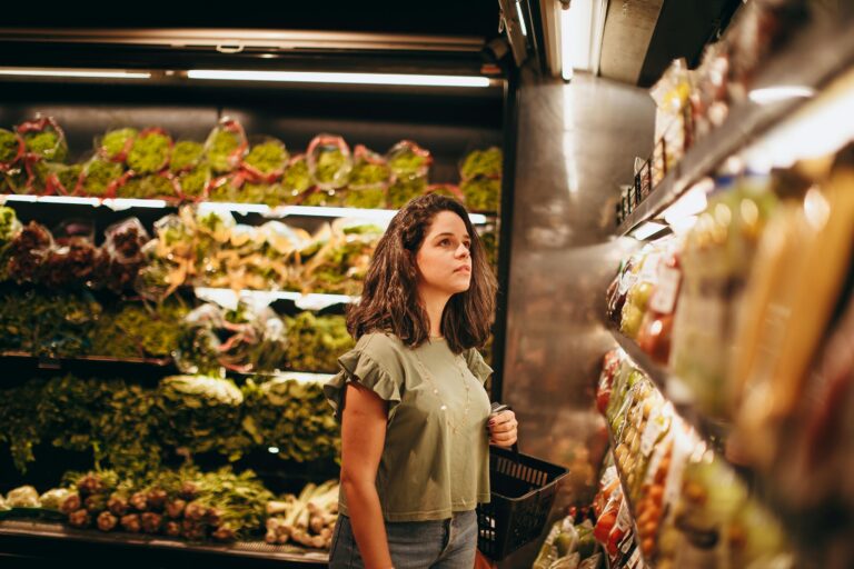 Introvert alone in quiet grocery store aisle early morning with soft lighting