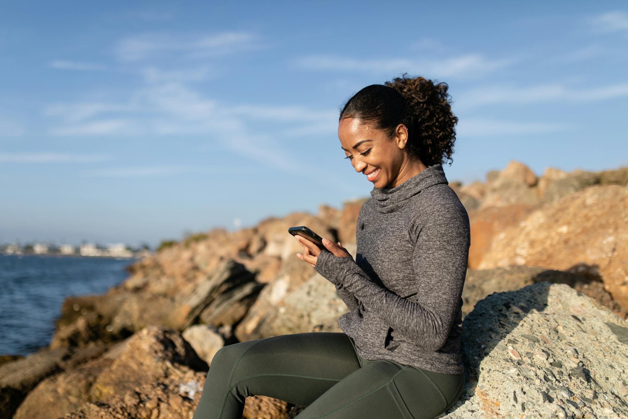 Person recording voice message while walking in nature outdoors