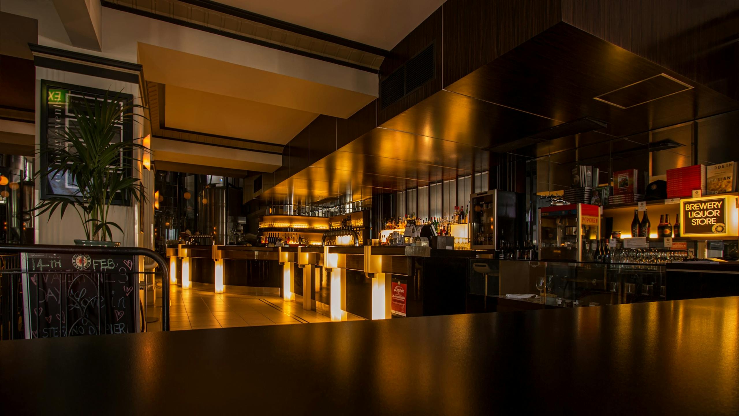 Stylish modern restaurant interior with warm lighting, elegant design, and luxurious nighttime ambiance.