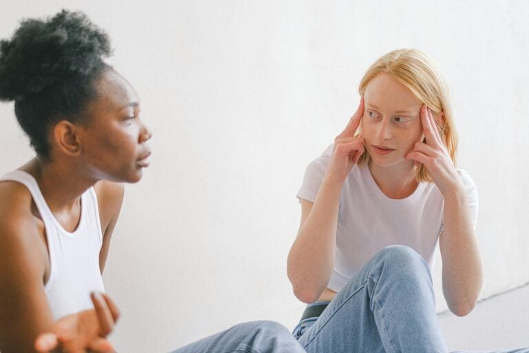 Two women having intense conversation indoors in casual attire