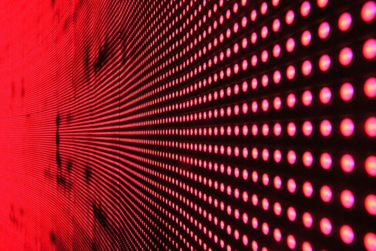 Vibrant abstract pattern of illuminated red LED lights in dynamic design.