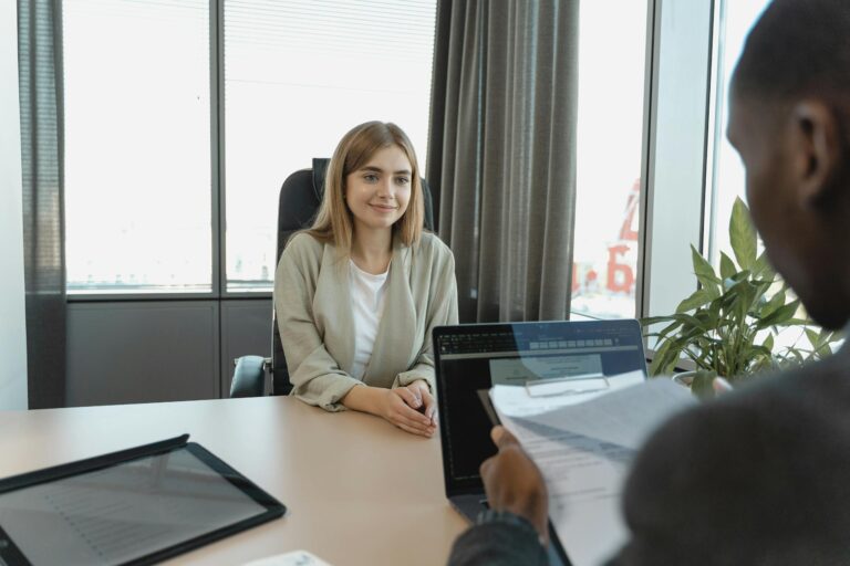 Young woman sitting confidently in modern office during job interview setting