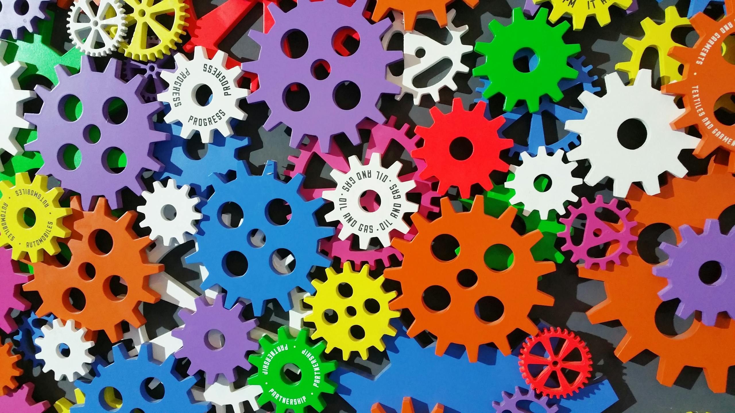 Colorful gears and machinery symbolizing creativity, innovation, and interconnected thinking.