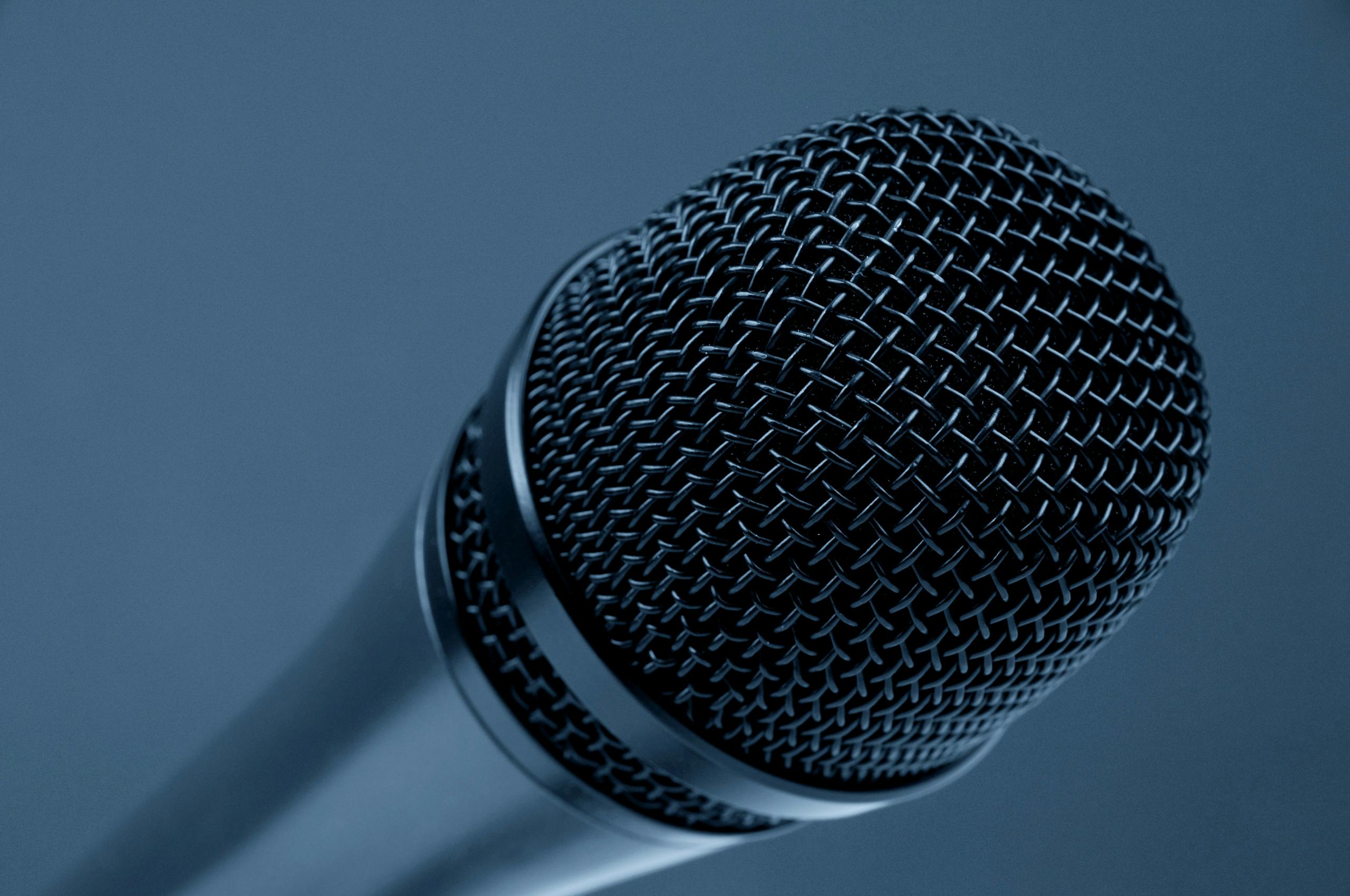 Close-up detailed view of microphone mesh design with blue monochrome background
