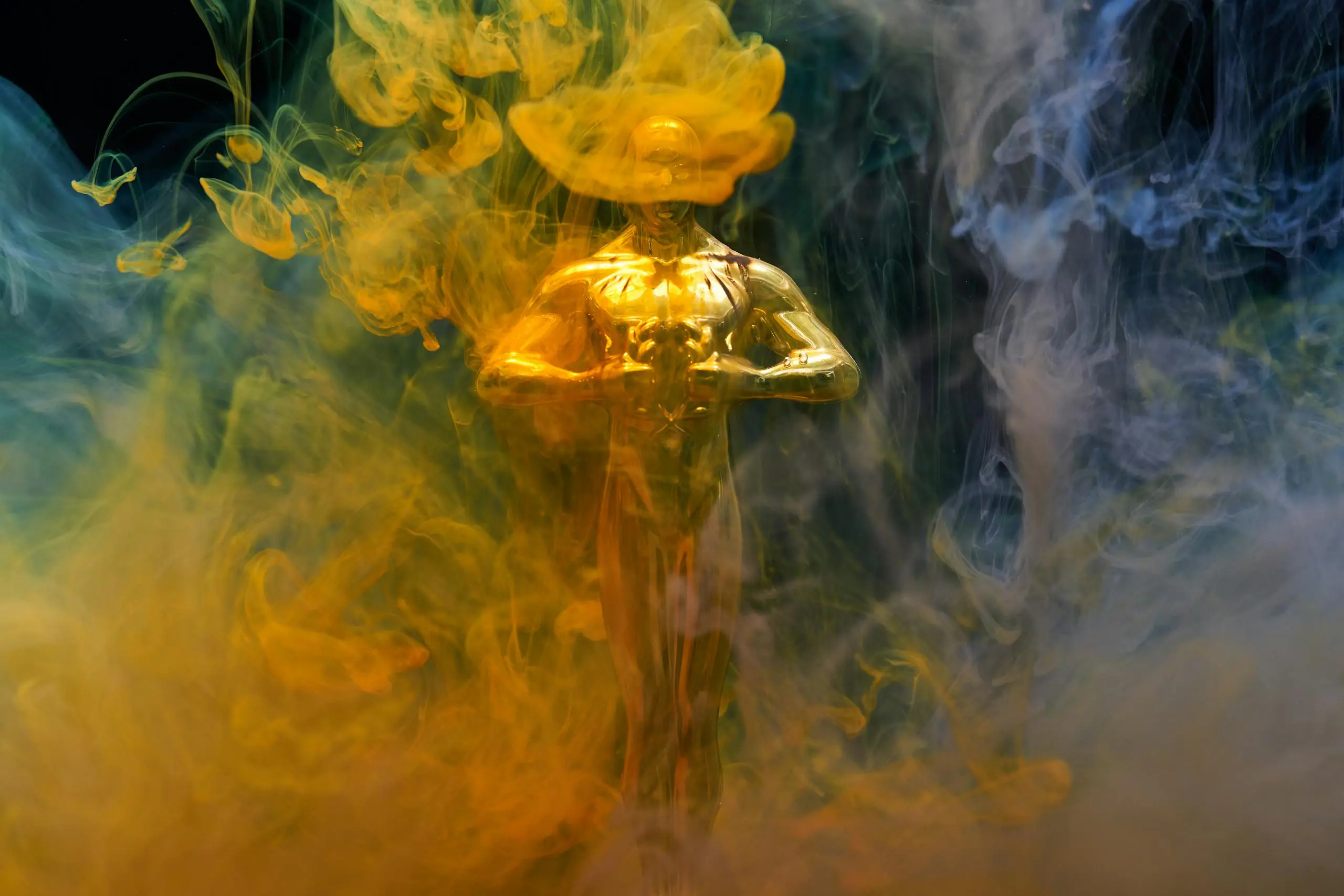 Golden statuette enveloped in vibrant yellow and blue smoke symbolizing achievement