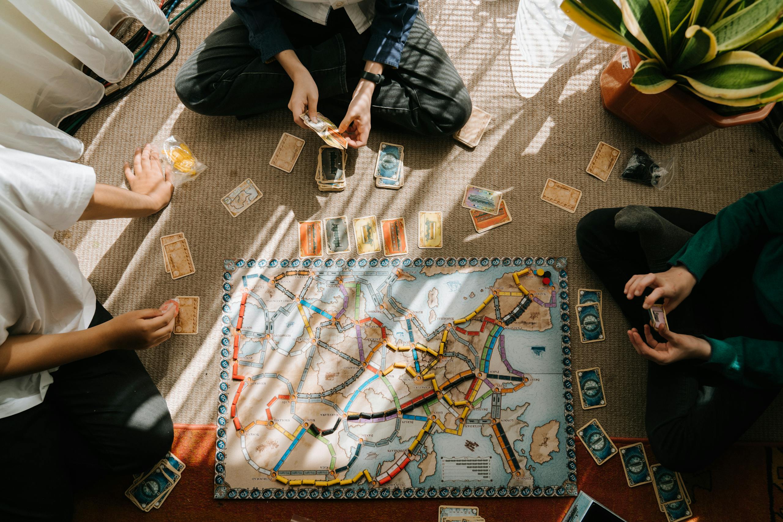 Group of children playing board game on carpet indoors