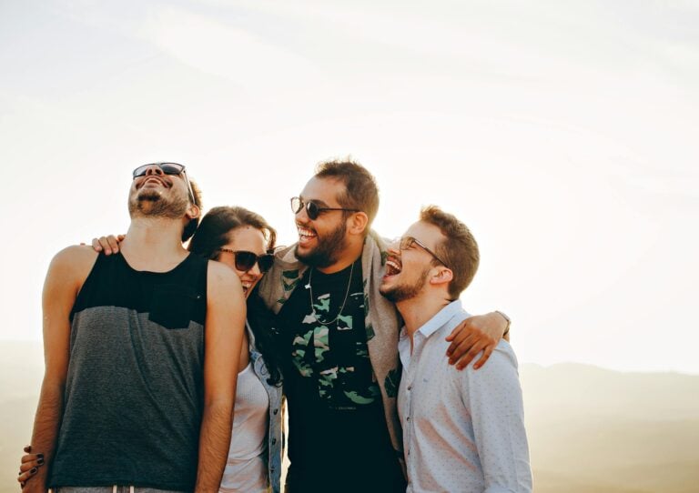 Group of young adults laughing and enjoying time together outdoors