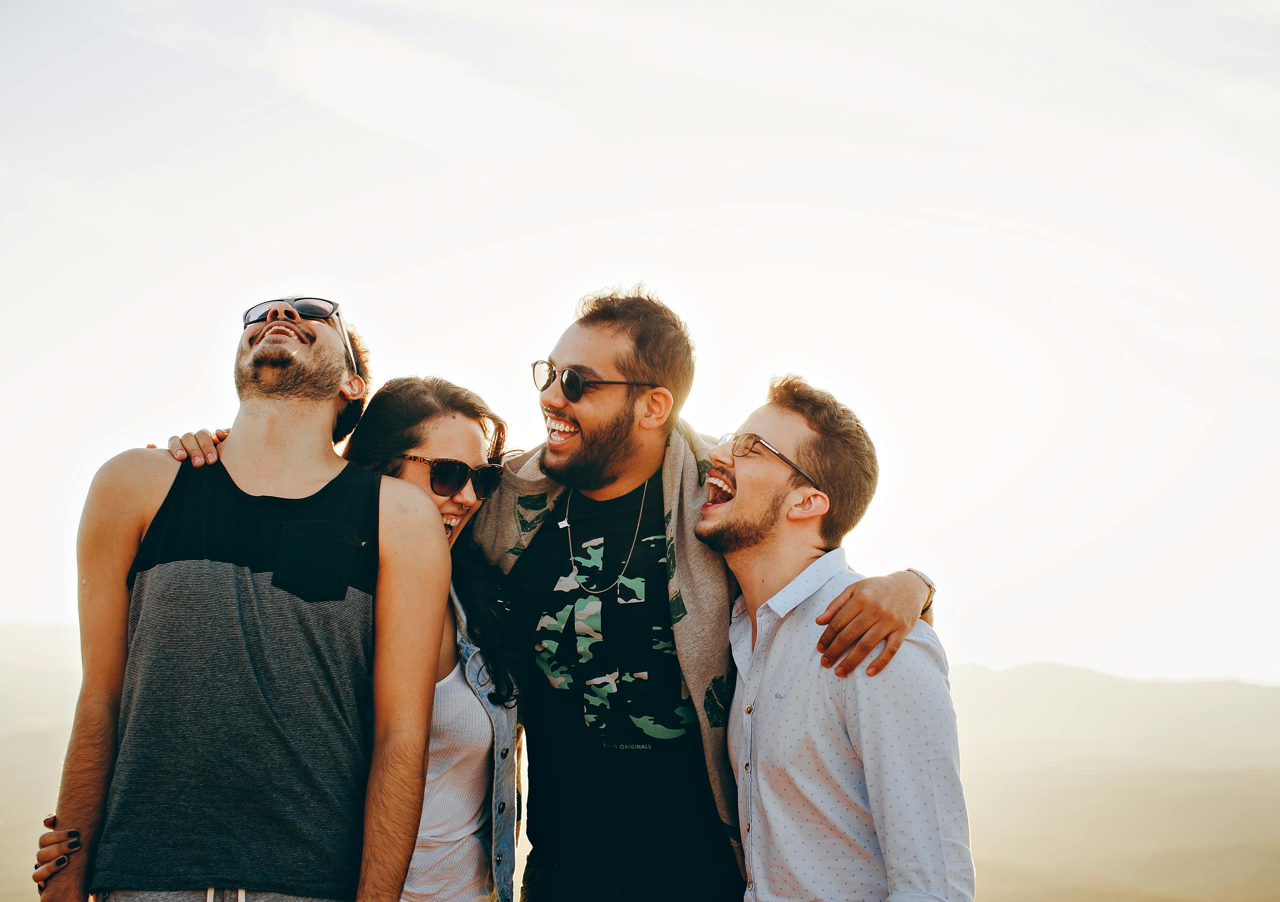 Group of young adults laughing and enjoying time together outdoors