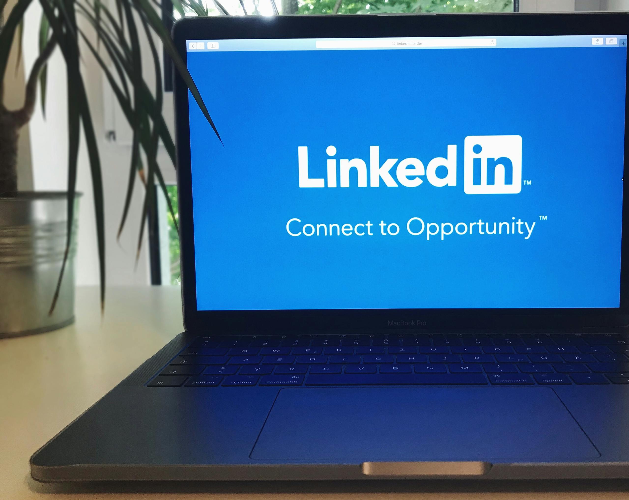 Laptop screen displaying LinkedIn logo with text connect to opportunity messaging.