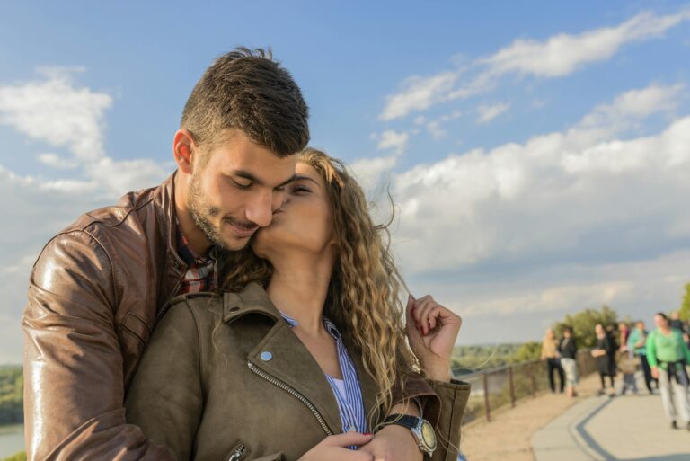 Loving couple embraces under clear sky showcasing romance and togetherness