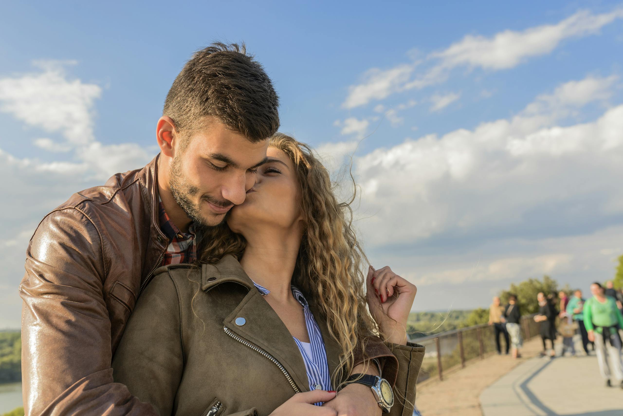 Loving couple embraces under clear sky showcasing romance and togetherness
