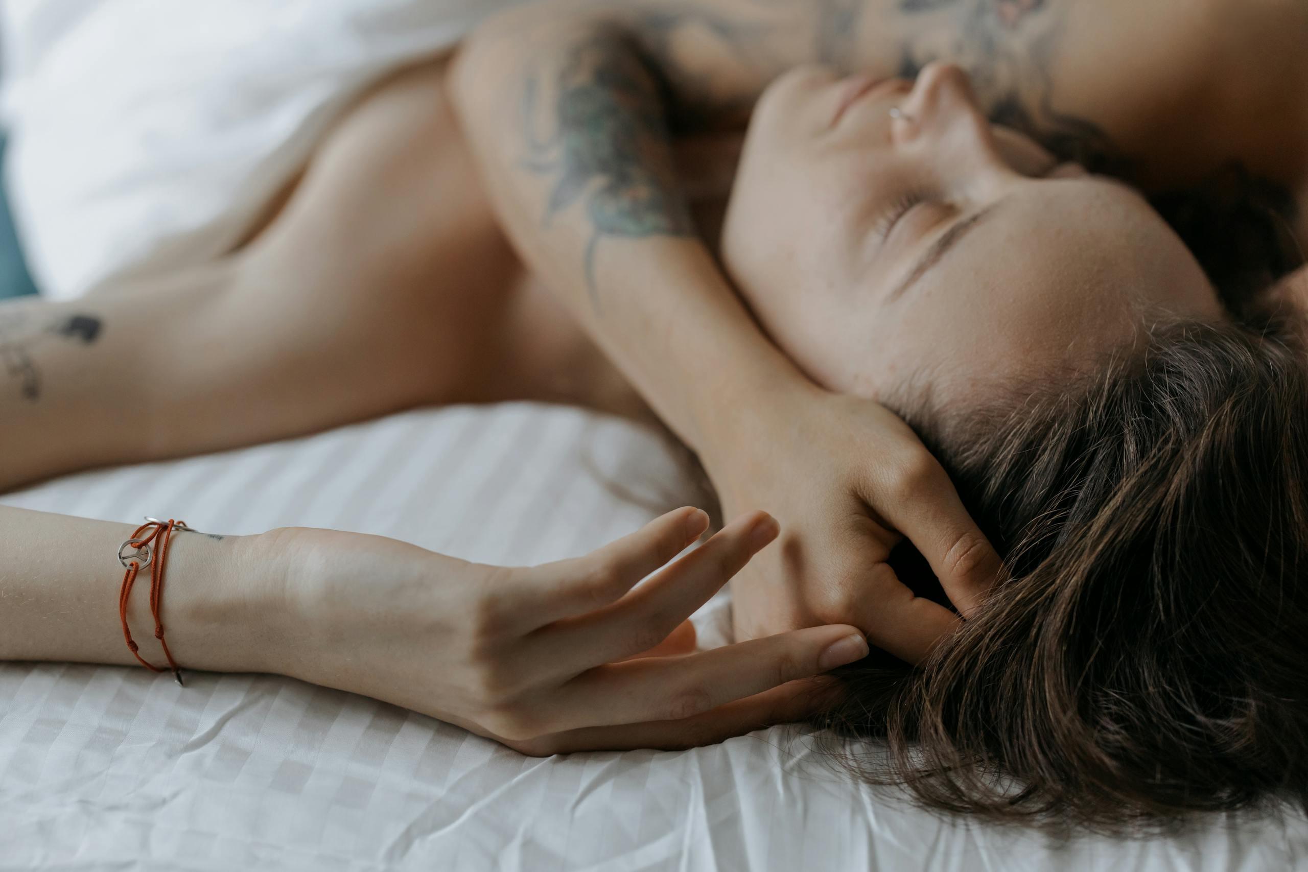Serene moment of couple embracing in bed expressing intimate peaceful feelings