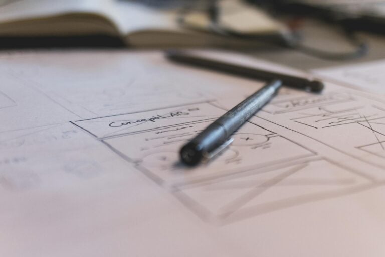 Notebook sketch with handwritten notes and pen for planning or design work