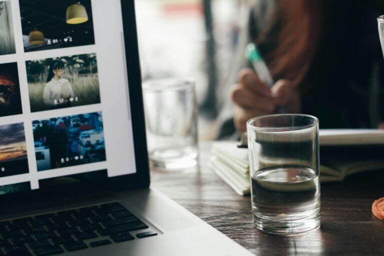 Workspace setup featuring laptop and glass on wooden desk in tan binh vietnam