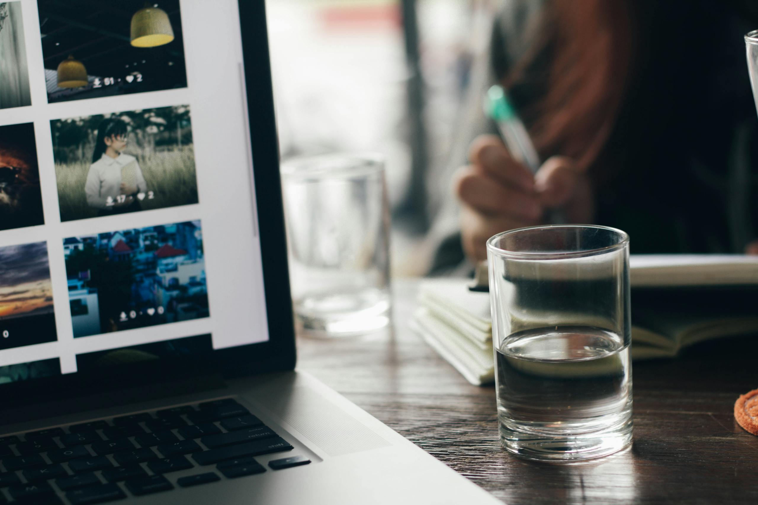 Workspace setup featuring laptop and glass on wooden desk in tan binh vietnam