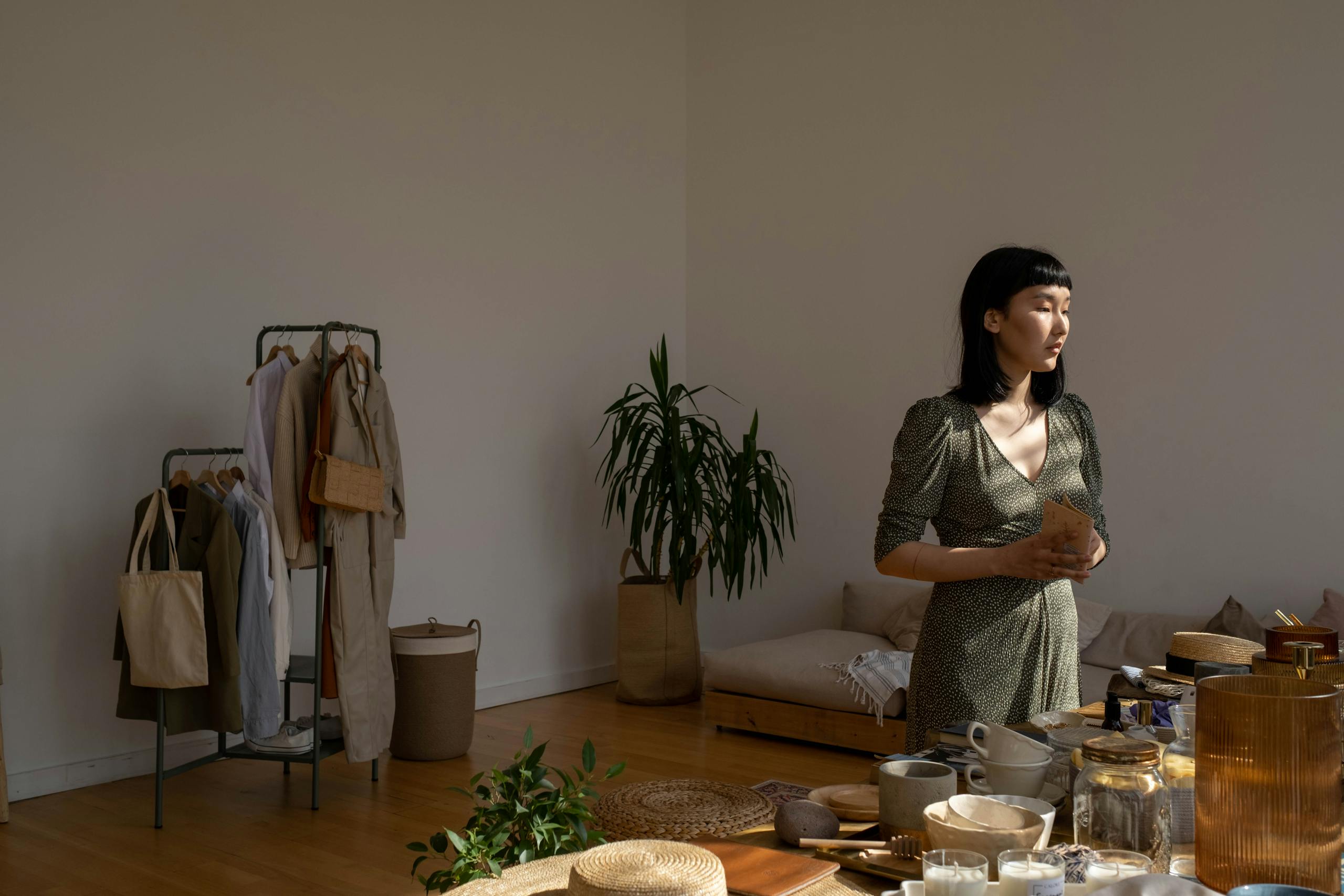Asian woman holding notebook in softly lit modern indoor space.