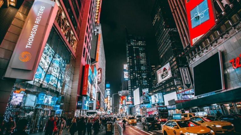 Bustling evening Times Square scene showcasing bright lights and lively crowded atmosphere