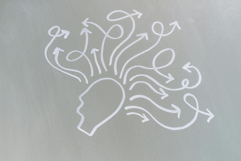 Chalk drawing of head with swirling arrows represents mental activity and thought process