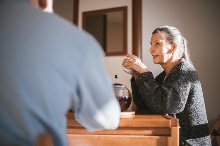 Cheerful senior couple enjoying coffee together in cozy home setting