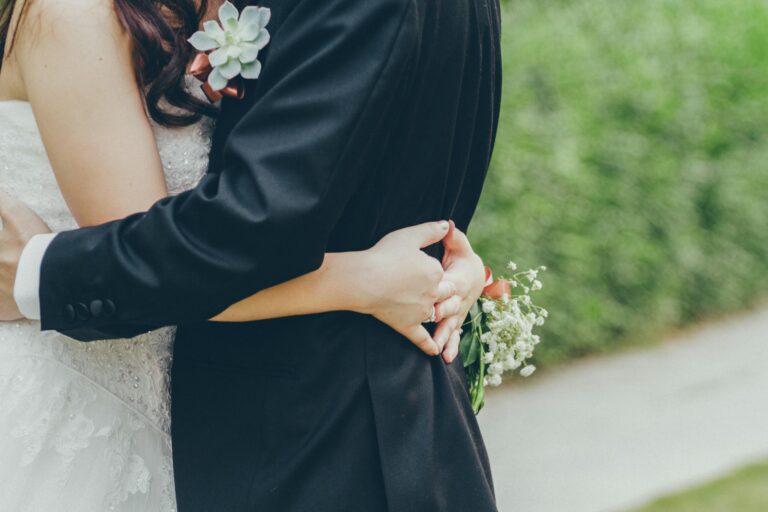 Bride and groom hugging in lush Kowloon garden capturing wedding romance
