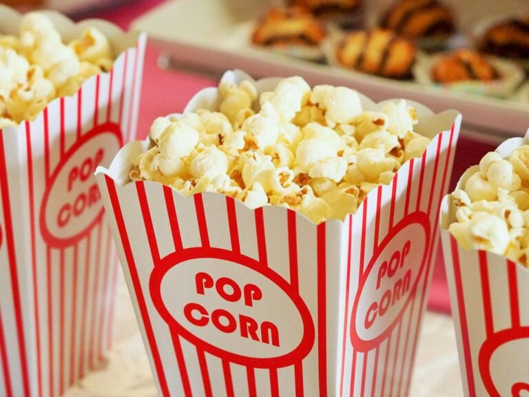 Close-up of gourmet popcorn in classic red and white striped cinema boxes
