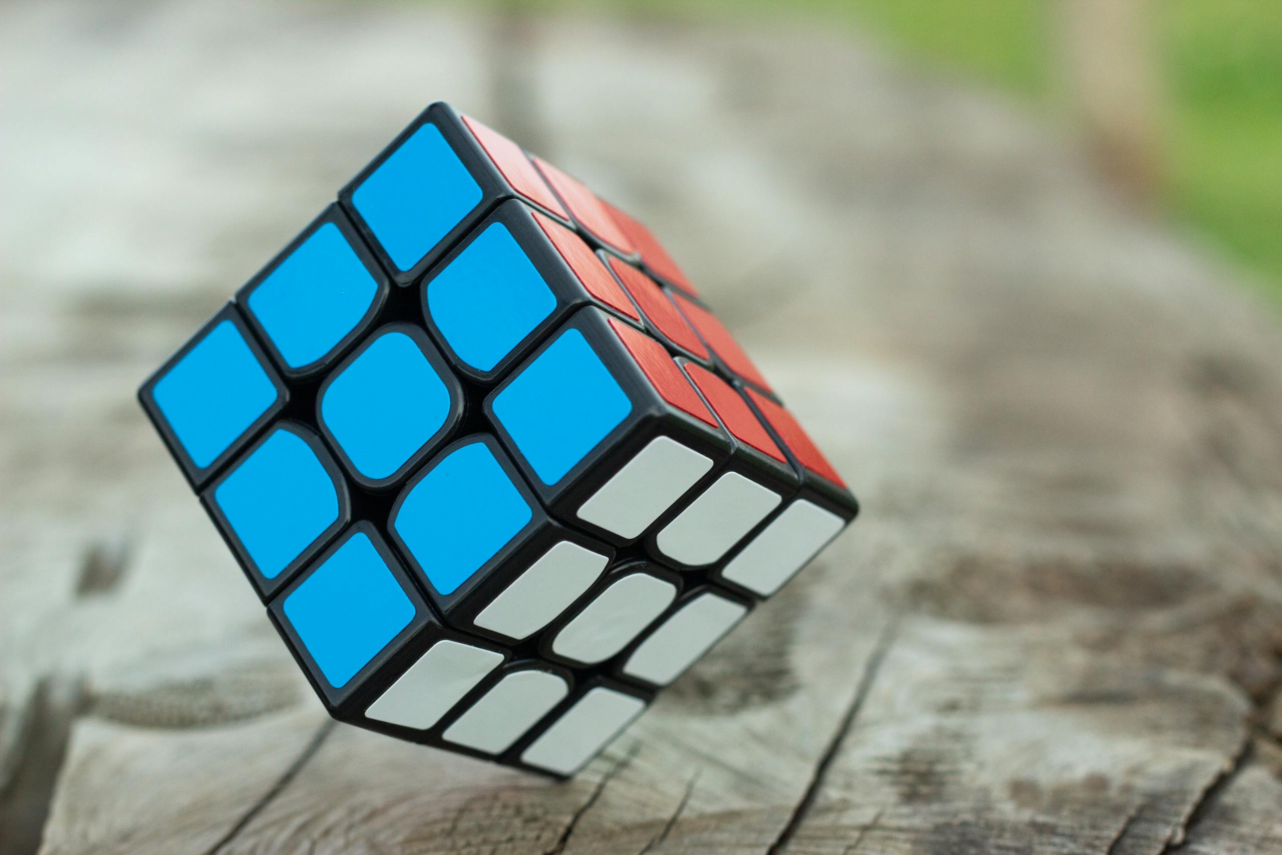 Colorful Rubik's cube resting on wooden surface showcasing vibrant geometric patterns