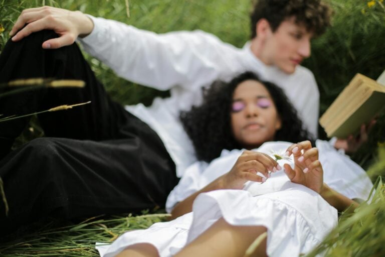 Couple relaxing in meadow enjoying summer nature love and tranquility