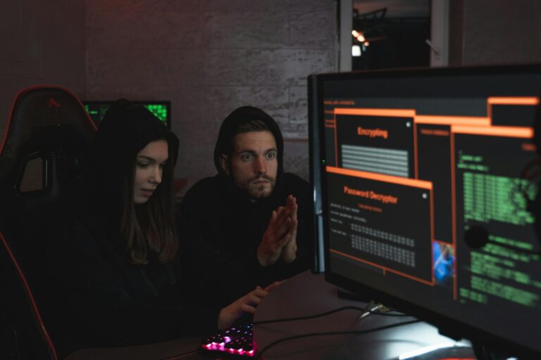 Cybersecurity experts in hoodies analyzing encrypted data on screens.