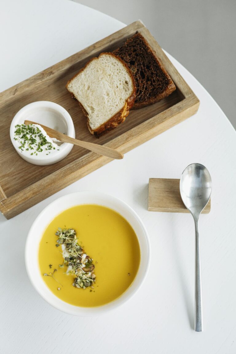 Delicious pumpkin soup with fresh bread and creamy dip for gourmet dining