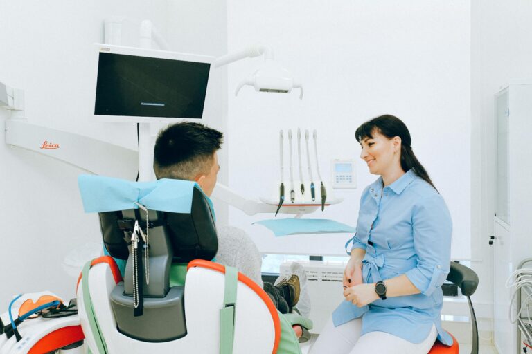 Dentist interacting with patient in bright modern dental clinic