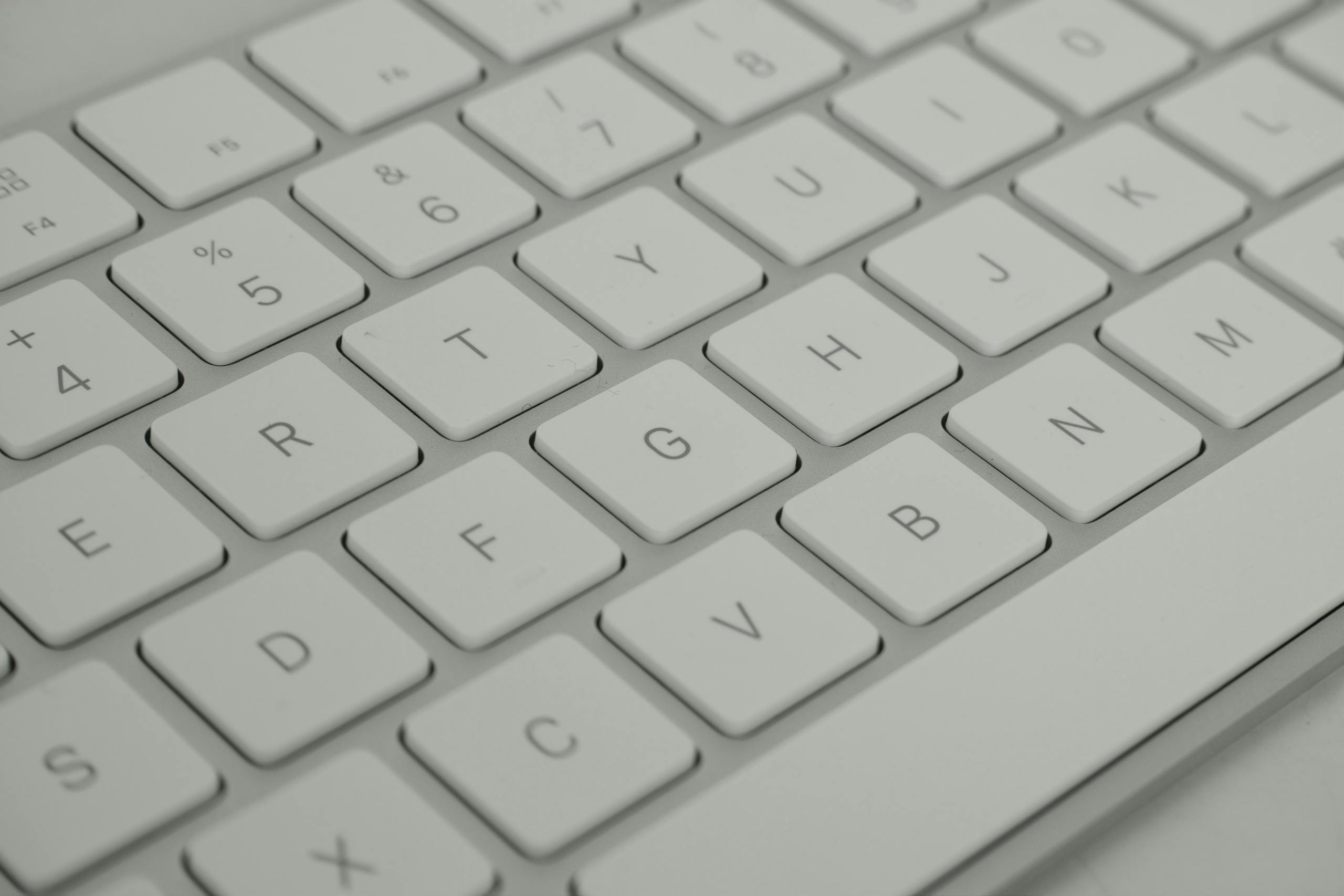 Detailed close-up of sleek white keyboard emphasizing modern technology