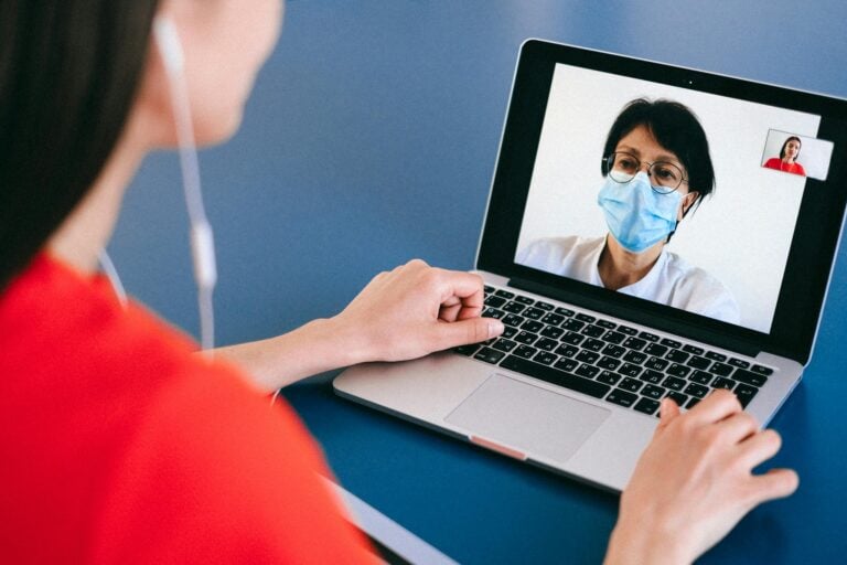 Doctor and patient engaged in remote video call telehealth consultation