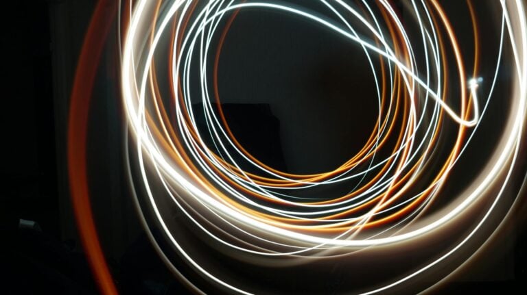 Abstract long exposure light streaks swirling on dark background