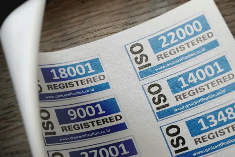 ISO certification stickers with registration numbers on paper documentation.