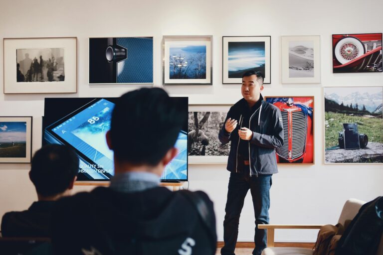 Man giving presentation in modern art gallery while engaging captivated audience