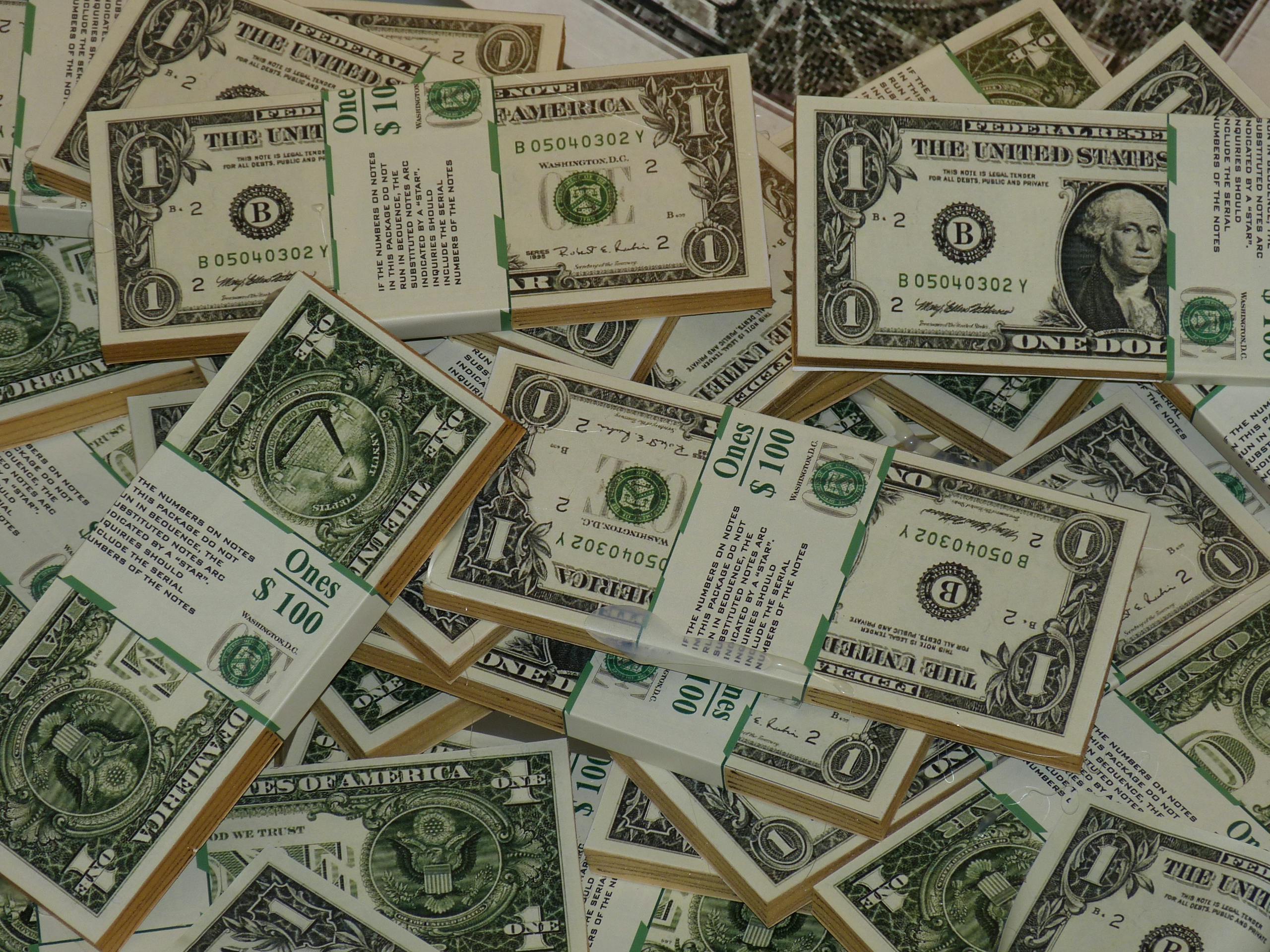 Numerous bundles of US dollar bills symbolizing wealth, finance, and savings