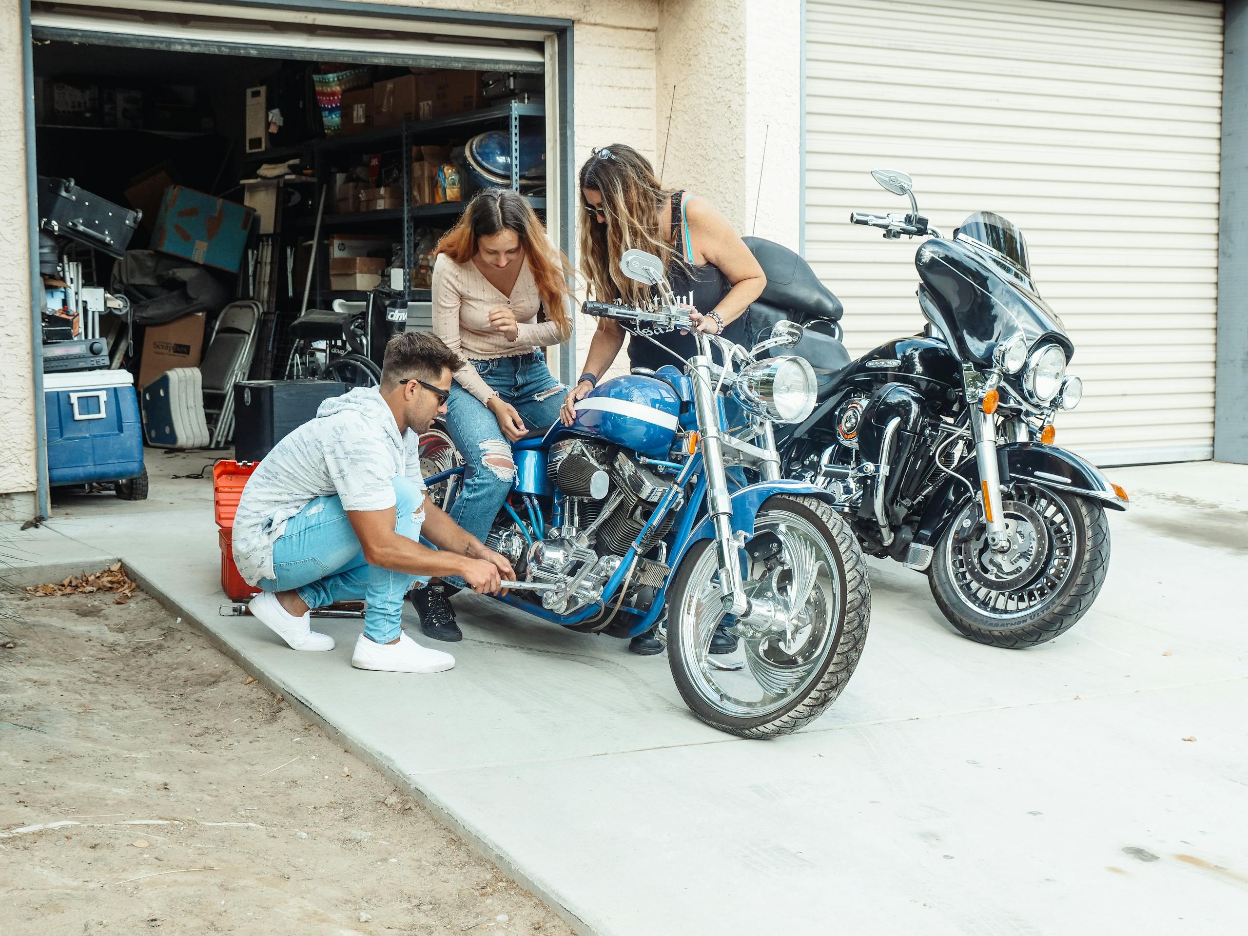 Two ISTPs working together on mechanical project in garage workshop